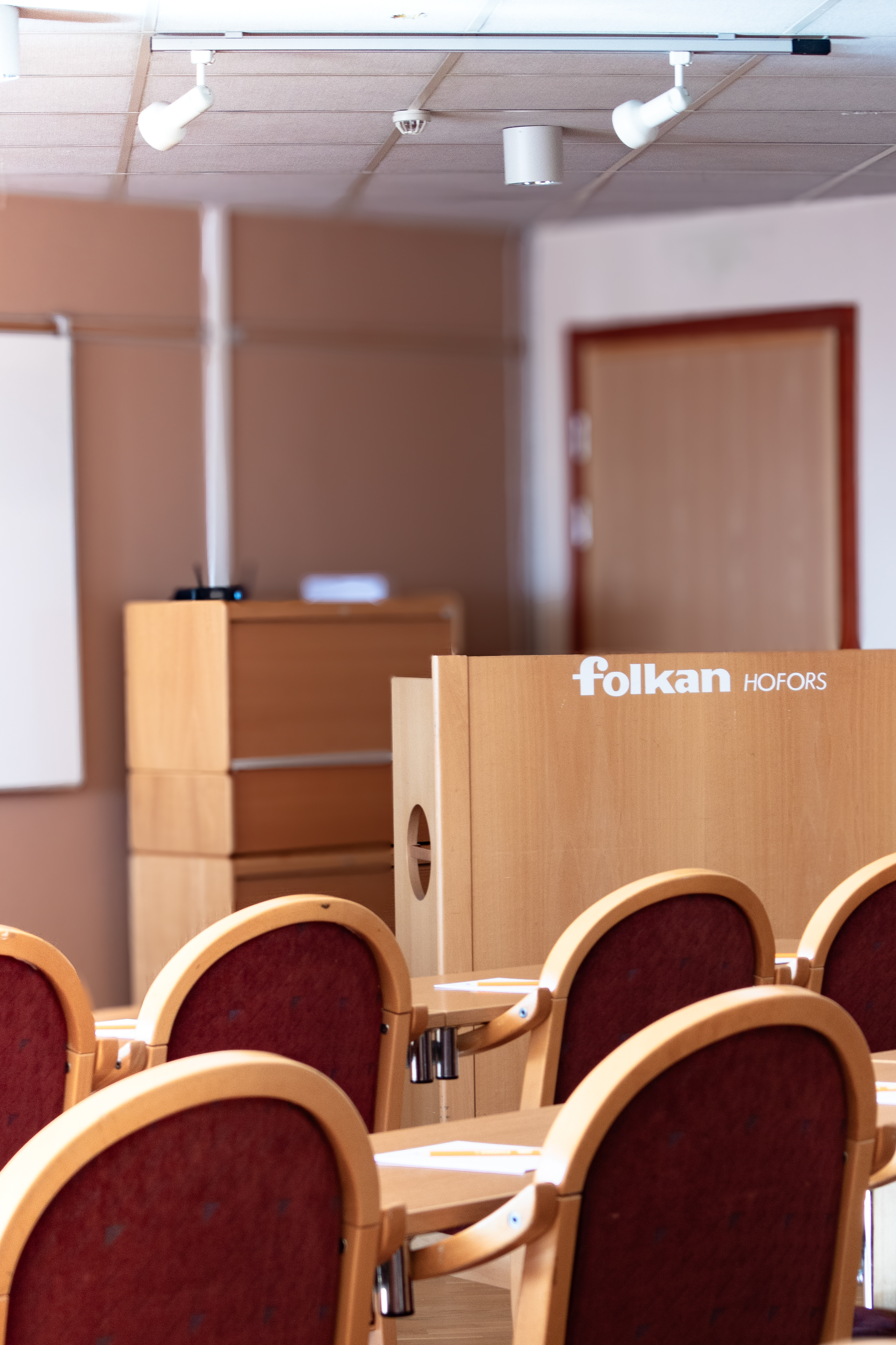 Konferenssal med Folkan-podium och röda stolar